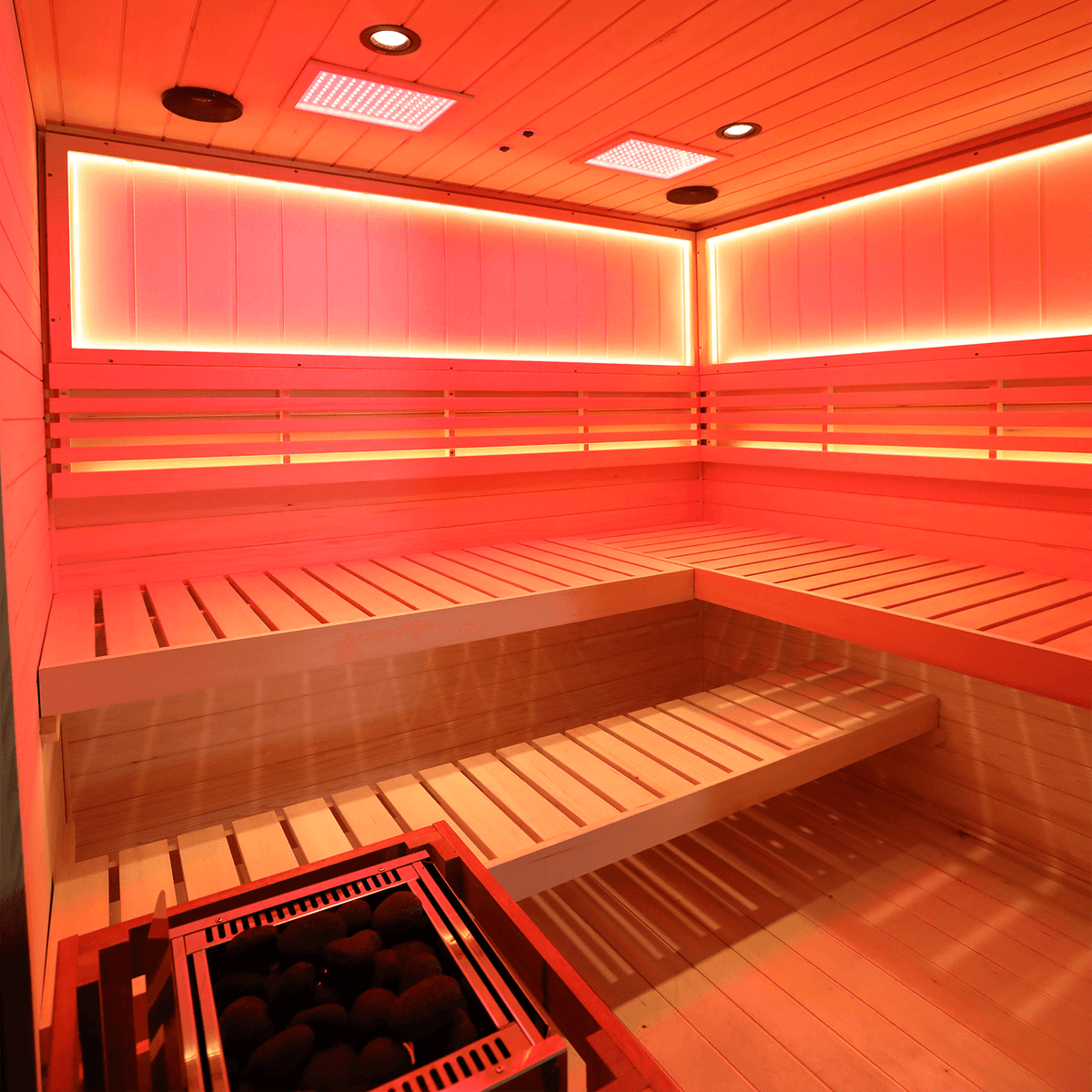 Interior view of upgraded four-person hemlock steam sauna cabin, featuring 660nm red light therapy and negative ion air refresh