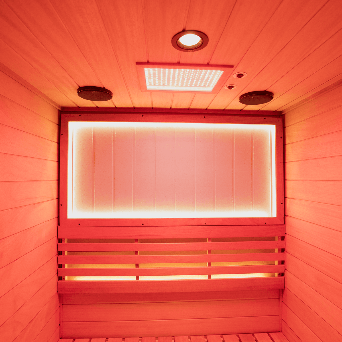 Interior shot of upgraded two-person mahogany steam sauna, featuring negative ion purification and 660nm red light therapy for home spa