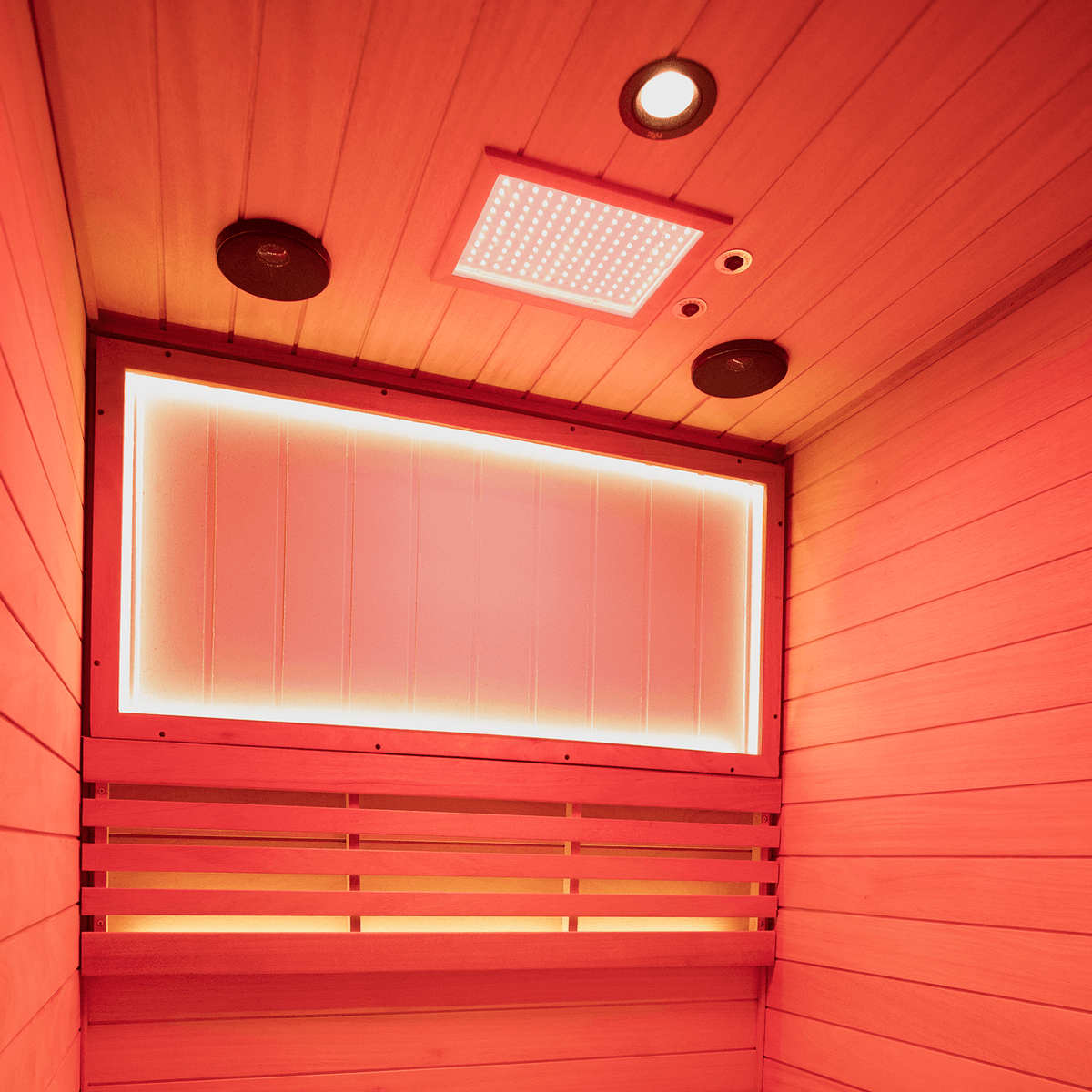 Close-up view of 660nm red light therapy panel inside 2-person mahogany indoor steam sauna with negative ion